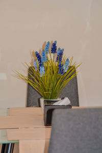 Close-up of potted plant on table against wall