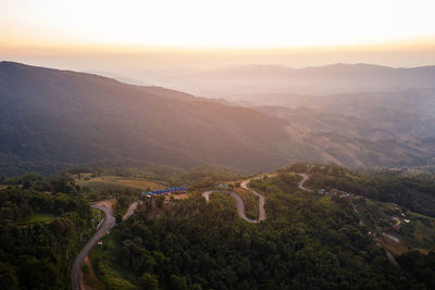 High angle view of winding road against sky during sunset