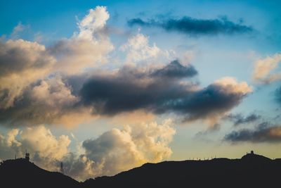 Low angle view of silhouette mountains against dramatic sky
