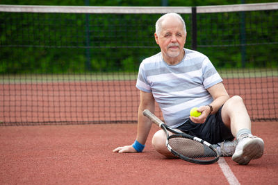 Portrait of man playing with ball