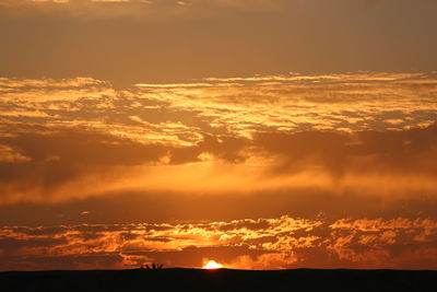 Low angle view of dramatic sky during sunset