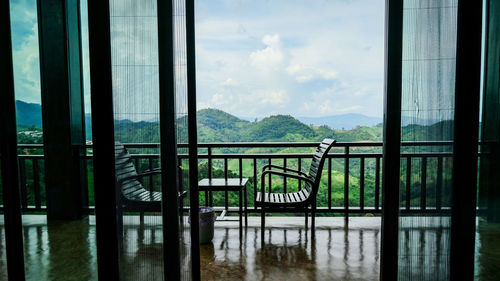 Chair for relaxation and watching view. overlooking the window of balcony with transparent curtain.