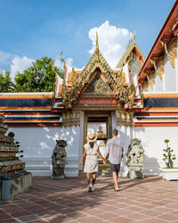 Rear view of woman standing in temple