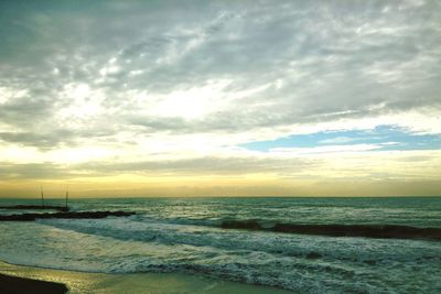 Scenic view of sea against cloudy sky