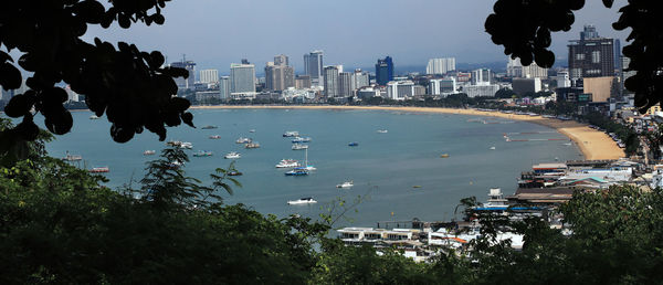 High angle view of buildings by sea against sky