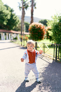 Portrait of boy on footpath