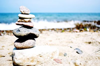 Scenic view of rocks stacked on beach