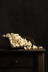 Close-up of food on table against black background