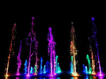 Close-up of illuminated lights against black background