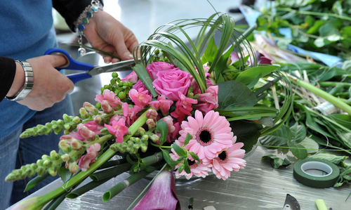 Close-up of florist making bouquet at table