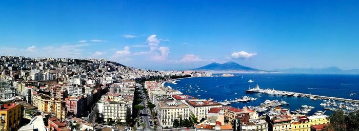 High angle view of naples' townscape by sea against sky