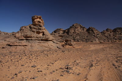 Rock formations on landscape against clear blue sky acacus moutain, libya