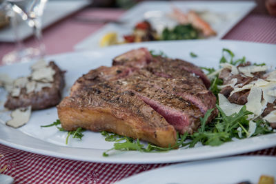 Close-up of steak in plate on table