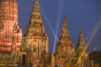 Low angle view of illuminated temples against sky at dusk