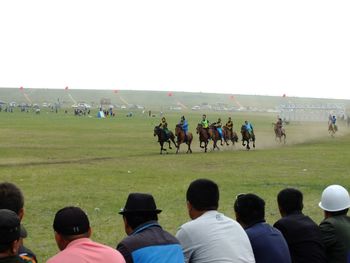 People on field against clear sky