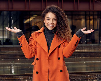Portrait of smiling young woman standing outdoors