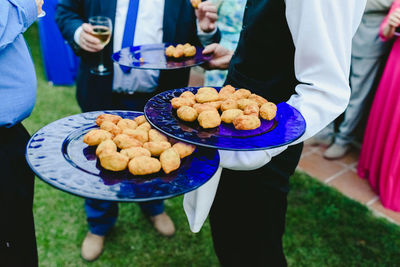 People standing by food