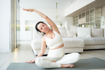 Portrait of pregnant woman meditating at home