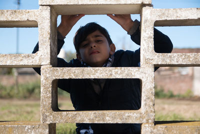 Portrait of boy standing outdoors