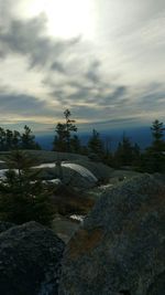 Scenic view of mountains against cloudy sky