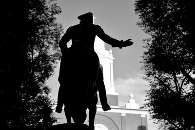 Low angle view of man statue against sky