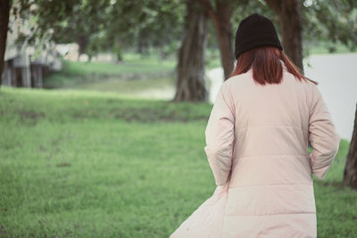 Rear view of woman standing on field