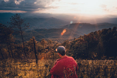 Rear view of woman on landscape against sky