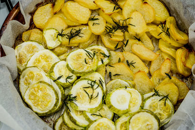 Slices of freshly baked potatoes and zucchini with dill and garlic