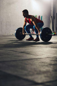 Full length of man leaning on skateboard