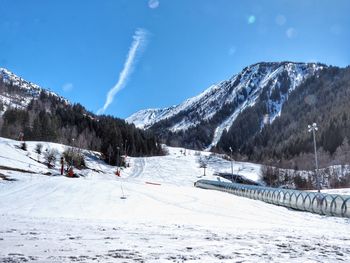 Scenic view of snow covered mountains against sky