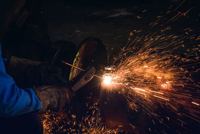 Cropped image of worker welding metal