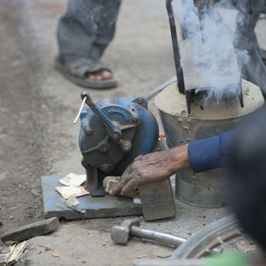 Low section of man working on metal structure