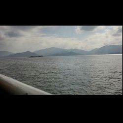 Scenic view of mountains against cloudy sky