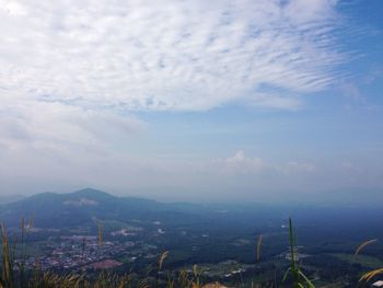 View of cityscape against cloudy sky