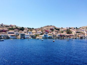 Townscape in front of sea against clear sky at halki