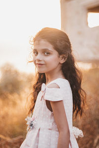 Portrait of young woman standing outdoors