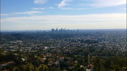 Cityscape against cloudy sky