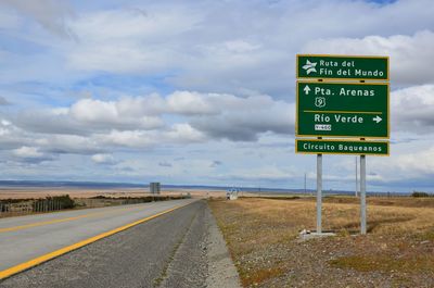 Road sign against sky