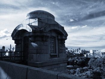 View of buildings against cloudy sky