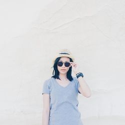 Portrait of woman standing on wall