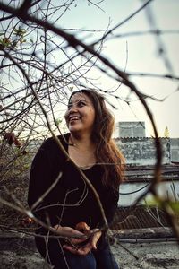 Happy woman seen through branches