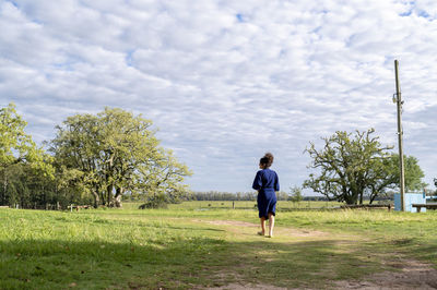 Woman walking outdoors in the field.