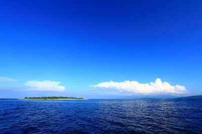 Scenic view of sea against blue sky