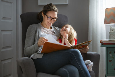 Mother and daugher enjoying reading a book on a casual afternoon