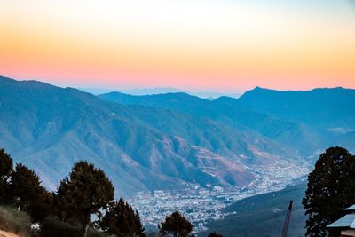 Scenic view of snowcapped mountains against sky during sunset