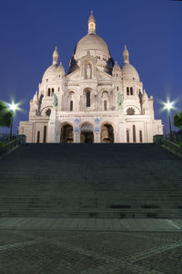 Facade of historic building against sky at night