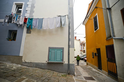 Clothesline hanging against wall in city