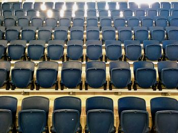 Empty blue chairs in stadium