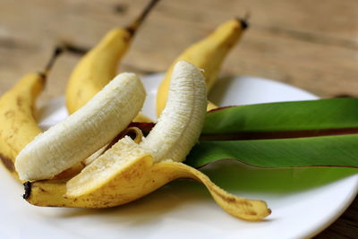 Bananas and leaves placed on old wooden floor.