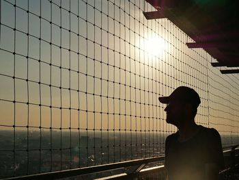 Silhouette man standing against sky during sunset